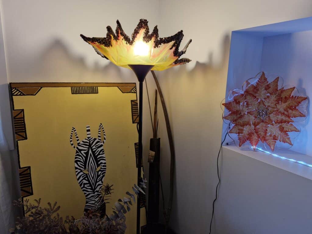 Illuminating Decorative room corner with artistic lamp, zebra artwork, and wall decoration.